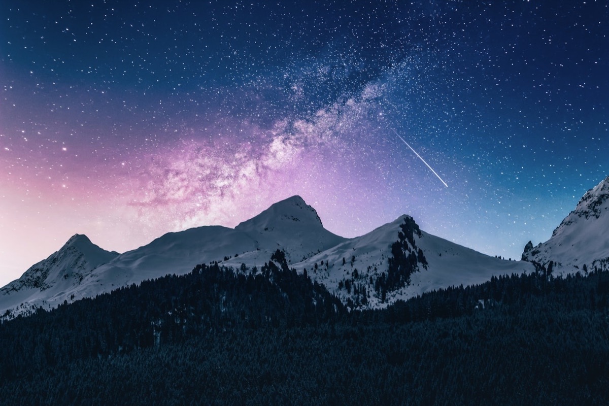 Cordillera nevada bajo un cielo estrellado